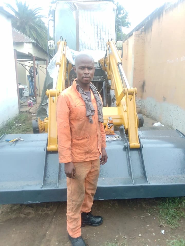 Repainted backhoe loader bucket after refurbishment